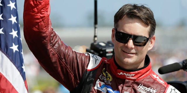 FILE - In this Feb. 22, 2015, file photo, Jeff Gordon gives a thumbs-up to the crowd as he in introduced before the Daytona 500 NASCAR Sprint Cup series auto race at Daytona International Speedway in Daytona Beach, Fla. Dale Earnhardt Jr. will miss two more races as he recovers from concussion-like symptoms and retired NASCAR champion Jeff Gordon will replace him at Indianapolis and Pocono. The announcement came Wednesday, July 20, 2016,  from Hendrick Motorsports, which said Earnhardt has not been cleared by doctors to drive. (AP Photo/John Raoux, File)