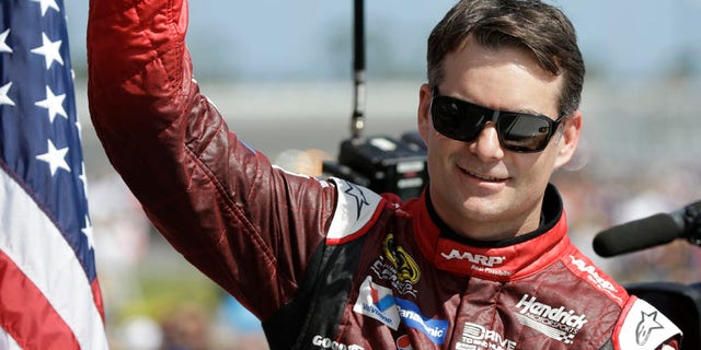 FILE - In this Feb. 22, 2015, file photo, Jeff Gordon gives a thumbs-up to the crowd as he in introduced before the Daytona 500 NASCAR Sprint Cup series auto race at Daytona International Speedway in Daytona Beach, Fla. Dale Earnhardt Jr. will miss two more races as he recovers from concussion-like symptoms and retired NASCAR champion Jeff Gordon will replace him at Indianapolis and Pocono. The announcement came Wednesday, July 20, 2016, from Hendrick Motorsports, which said Earnhardt has not been cleared by doctors to drive. (AP Photo/John Raoux, File)