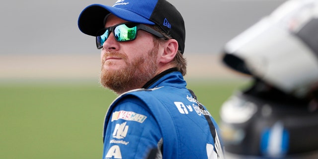 File-This July 1, 2016, file photo shows Dale Earnhardt Jr. watching the leader-board during qualifying for a NASCAR Sprint Cup auto race at Daytona International Speedway in Daytona Beach, Fla. (AP Photo/Wilfredo Lee, File)