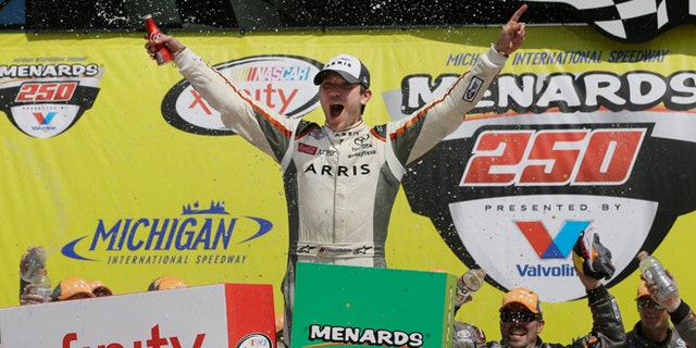 Daniel Suarez yells after winning the NASCAR Xfinity series auto race at Michigan International Speedway, Saturday, June 11, 2016 in Brooklyn, Mich. The was the first win for Suarez. (AP Photo/Carlos Osorio)