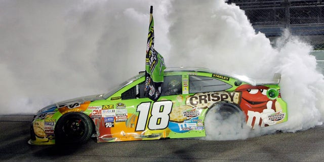 FILE - In this Nov. 22, 2015, file photo, Kyle Busch  does a burnout after winning the NASCAR Sprint Cup Series auto race and the season title,  at Homestead-Miami Speedway in Homestead, Fla. With four-time champion Jeff Gordon retired and three-time champ Tony Stewart sidelined with a broken back, the NASCAR season begins with a much different look and a new rules package. (AP Photo/Darryl Graham)
