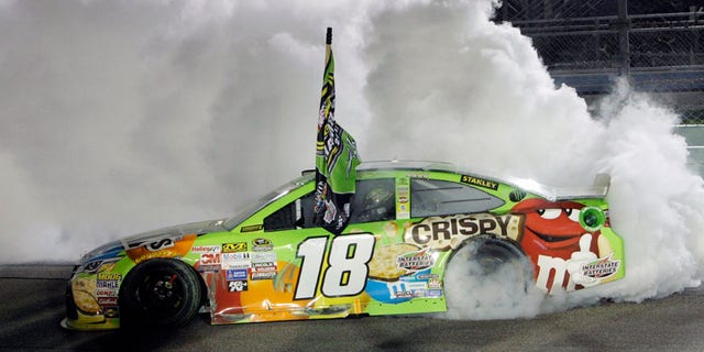 FILE - In this Nov. 22, 2015, file photo, Kyle Busch does a burnout after winning the NASCAR Sprint Cup Series auto race and the season title, at Homestead-Miami Speedway in Homestead, Fla. With four-time champion Jeff Gordon retired and three-time champ Tony Stewart sidelined with a broken back, the NASCAR season begins with a much different look and a new rules package. (AP Photo/Darryl Graham)