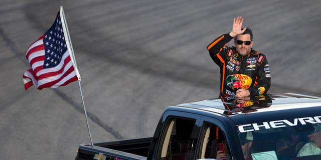 Sprint Cup Series driver Tony Stewart waves to the crowd before the start of the NASCAR Sprint Cup auto race at Atlanta Motor Speedway Sunday, Aug. 31, 2014, in Hampton, Ga. Stewart was racing for the first time since being involved in a fatal dirt track accident in upstate New York. (AP Photo/John Bazemore)