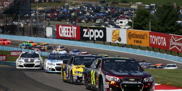 WATKINS GLEN, NY - AUGUST 10: Jeff Gordon, driver of the #24 Drive to End Hunger Chevrolet, leads a pack of cars during the NASCAR Sprint Cup Series Cheez-It 355 at Watkins Glen International on August 10, 2014 in Watkins Glen, New York. (Photo by Chris Graythen/NASCAR via Getty Images)