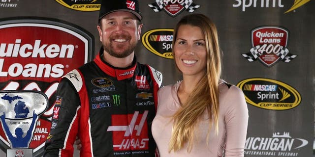 BROOKLYN, MI - JUNE 14: Kurt Busch, driver of the #41 Haas Automation Chevrolet, and his girlfriend Ashley Van Metre celebrate in an alternate Victory Lane after winning the NASCAR Sprint Cup Series Quicken Loans 400 at Michigan International Speedway on June 14, 2015 in Brooklyn, Michigan. (Photo by Sean Gardner/NASCAR via Getty Images)