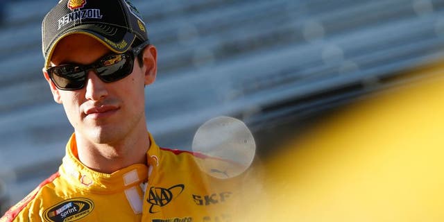 MARTINSVILLE, VA - OCTOBER 30: Joey Logano, driver of the #22 Shell Pennzoil Ford, stands on the grid during qualifying for the NASCAR Sprint Cup Series Goody's Headache Relief Shot 500 at Martinsville Speedway on October 30, 2015 in Martinsville, Virginia. (Photo by Brian Lawdermilk/NASCAR via Getty Images)