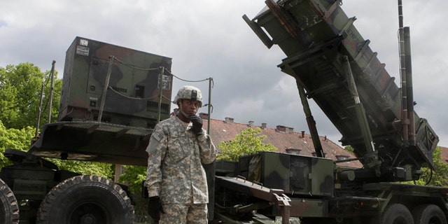 May 26, 2010: A U.S. soldier stands next to a Patriot surface-to-air missile battery at an army base in Morag, Poland.