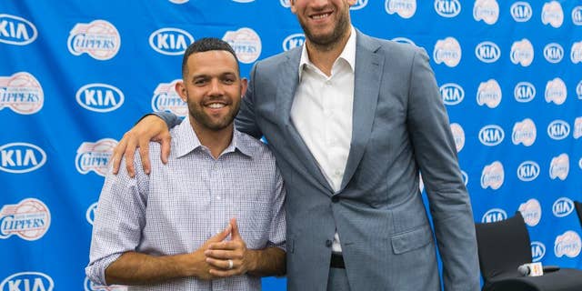 Free agent guard Jordan Farmar, left, and center Spencer Hawes are introduced as the new Los Angeles Clippers players during a news conference in Los Angeles Thursday, July 10, 2014. (AP Photo/Damian Dovarganes)