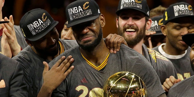 Cleveland Cavaliers forward LeBron James, center, celebrates with teammates after Game 7 of basketball's NBA Finals against the Golden State Warriors in Oakland, Calif., Sunday, June 19, 2016. The Cavaliers won 93-89. (AP Photo/Marcio Jose Sanchez)