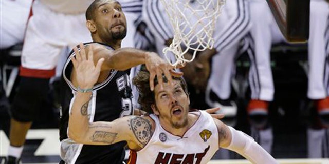 June 18, 2013: San Antonio Spurs power forward Tim Duncan (21) blocks the shot of Miami Heat shooting guard Mike Miller (13) during the second half of Game 6 of the NBA Finals basketball game.