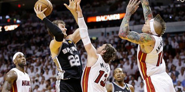 June 9, 2013: San Antonio Spurs center Tiago Splitter heads to the hoop under pressure from the Miami Heat's Chris Andersen Mike Miller as LeBron James looks on during the first half of Game 2 of the NBA Finals basketball game.