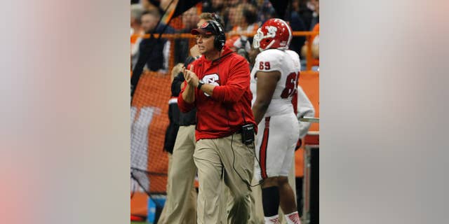 North Carolina State’s head coach Dave Doeren calls out to his players in the third quarter of an NCAA college football game against Syracuse in Syracuse, N.Y., Saturday, Nov. 1, 2014. North Carolina State won 24-17. (AP Photo/Nick Lisi)
