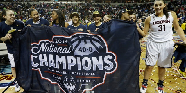 April 8, 2014: The Connecticut team celebrate their win over Notre Dame in the championship game in the Final Four of the NCAA women's college basketball tournament in Nashville, Tenn. (AP Photo/Mark Humphrey)