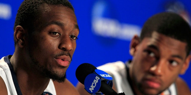 April 3, 2011: Connecticut's Kemba Walker, left, speaks during a news conference as teammate Roscoe Smith looks on before a practice session for the men's NCAA Final Four college basketball championship game in Houston.