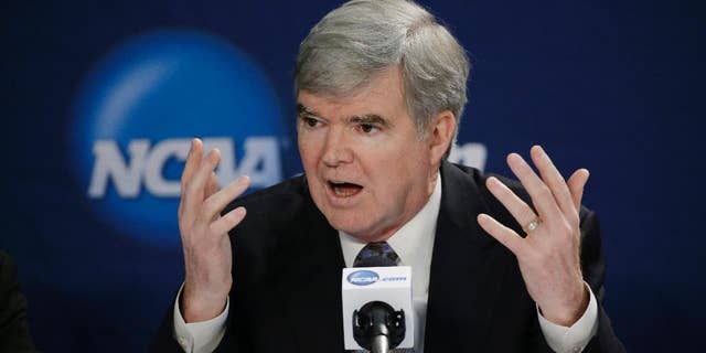 FILE - In this April 6, 2014 file photo, NCAA President Mark Emmert answers a question at a news conference in Arlington, Texas. The NCAA's board of directors is scheduled to discuss and endorse a 57-page overhaul plan that would hand far more power to five major conferences to decide how to treat and perhaps satisfy their athletes.(AP Photo/David J. Phillip, File)