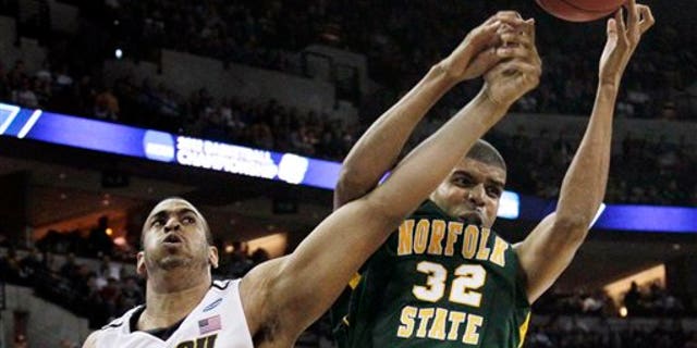 March 16: Missouri center Steve Moore, left, battles for a rebound with Norfolk State forward Marcos Tamares, right, during the first half of an NCAA college basketball tournament game at CenturyLink Center in Omaha, Neb.