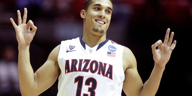 Johnson gestures after making a three-point basket against Gonzaga Sunday, March 23, 2014, in San Diego.