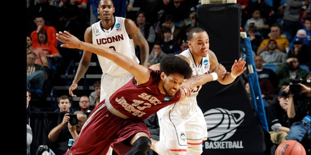 Saint Joseph's DeAndre Bembry (43) and Connecticut's Shabazz Napier, right, fight for control of the ball during the first half of a second-round game in the NCAA college basketball tournament in Buffalo, N.Y., Thursday, March 20, 2014. (AP Photo/Bill Wippert)