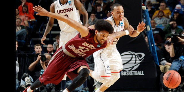 Saint Joseph's DeAndre Bembry (43) and Connecticut's Shabazz Napier, right, fight for control of the ball during the first half of a second-round game in the NCAA college basketball tournament in Buffalo, N.Y., Thursday, March 20, 2014. (AP Photo/Bill Wippert)
