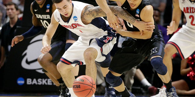 March 26, 2015: Arizona guard Gabe York, center left, and Xavier guard Larry Austin Jr. battle for a loose ball during the second half of a college basketball regional semifinal in the NCAA Tournament in Los Angeles. (AP Photo/Jae C. Hong)
