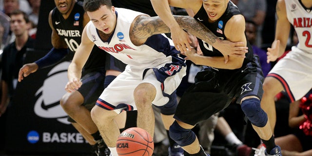 March 26, 2015: Arizona guard Gabe York, center left, and Xavier guard Larry Austin Jr. battle for a loose ball during the second half of a college basketball regional semifinal in the NCAA Tournament in Los Angeles. (AP Photo/Jae C. Hong)
