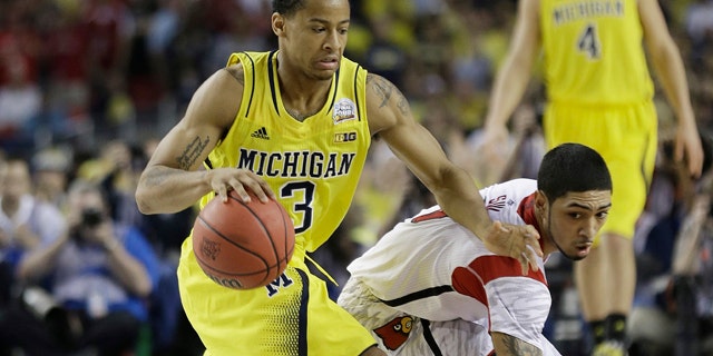 April 8, 2013: Louisville guard Peyton Siva (3) and Michigan guard Trey Burke (3) work during the second half of the NCAA Final Four tournament college basketball championship game.