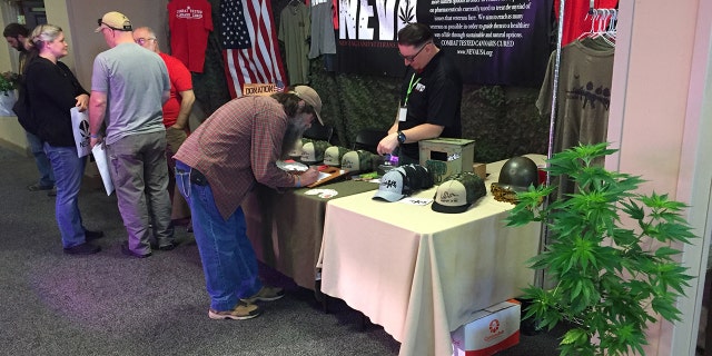 Derek Cloutier (right), president and founder of the New England Veterans Alliance, meets with other veterans at the NECANN cannabis & hemp convention in Burlington, Vermont. Cloutier organized and will be speaking at a Memorial Day rally in Washington, D.C., to promote veterans' access to legal marijuana.