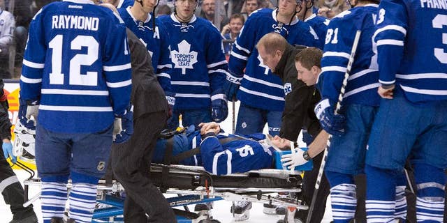 Toronto Maple Leafs' Paul Ranger is taken off the ice on a stretcher after hitting the boards head first from a check by Tampa Bay Lightning's Alex Killorn during first period NHL action in Toronto on Wednesday March 19, 2014. (AP Photo/The Canadian Press, Frank Gunn)