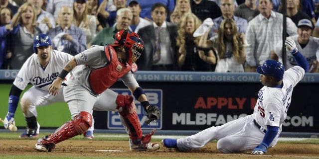 October 14, 2013: Carl Crawford slides safely past St. Louis Cardinals catcher Yadier Molina during the eighth inning of Game 3 of the National League baseball championship series Monday in Los Angeles. (AP Photo/Chris Carlson)