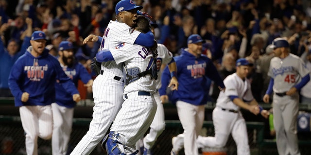 Chicago Cubs catcher Willson Contreras and relief pitcher Aroldis Chapman (54) celebrate after Game 6 of the National League baseball championship series against the Los Angeles Dodgers Saturday, Oct. 22, 2016, in Chicago. The Cubs won 5-0 to win the series and advance to the World Series against the Cleveland Indians. (AP Photo/David J. Phillip)
