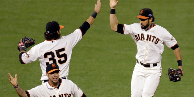 San Francisco Giants' Brandon Crawford (35), Angel Pagan, right, and Gregor Blanco celebrate after Game 6 of baseball's National League championship series against the St. Louis Cardinals Sunday, Oct. 21, 2012, in San Francisco. The Giants won 6-1 to tie the series at 3-3. (AP Photo/Eric Risberg)