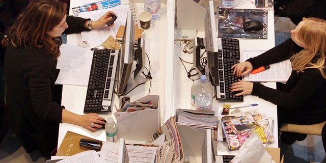 LONDON - NOVEMBER 03: Production staff on the weekly fashion magazine, Grazia edit the magazine in a temporary office inside the Westfield shopping centre on November 3, 2008 in London. For one week Grazia magazine is being produced in the Westfield shopping centre and are offering shoppers free make-overs, fashion consultations and advice on pursuing a modeling career. (Photo by Oli Scarff/Getty Images)