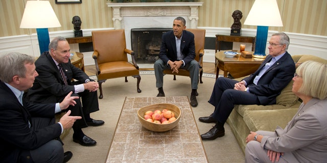 From left, Sen. Dick Durbin, D-Ill., Sen. Charles Schumer, D-N.Y., President Barack Obama, Senate Majority Leader Harry Reid of Nev., Sen. Patty Murray, D-Wash., meet in the Oval Office of the White House, Saturday, Oct. 12, 2013, in Washington. The federal government remains partially shut down and faces a first-ever default between Oct. 17 and the end of the month. (AP Photo/Carolyn Kaster)