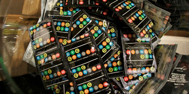 Condoms labeled like the city's subway lines to be given out for free by New York city's health department sit in a bowl inside a Kenneth Cole store, Wednesday, Feb. 14, 2007 in New York. Fashion designer Kenneth Cole joined in the campaign and designed special clothing with tiny pockets to hold the condoms. With the unveiling of the NYC Condom, New York became the first in the nation with an official brand. (AP Photo/Kathy Willens)