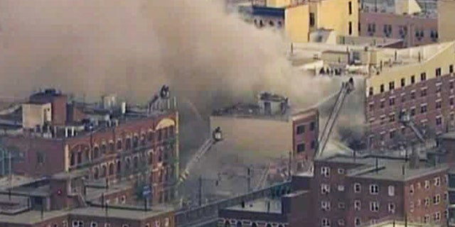 In this image taken from video from WABC, firefighters battle a blaze at the site of a possible explosion and building collapse in the East Harlem neighborhood of New York, Wednesday, March 12, 2014. (AP Photo/WABC-TV)