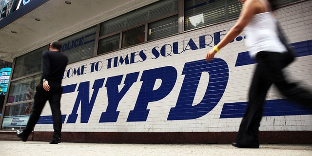 NEW YORK, NY - AUGUST 12: People walk by a New York Police Department (NYPD) outpost in Times Square on August 12, 2013 in New York City. The controversial policy employed by the NYPD in high crime neighborhoods known as stop and frisk, has been given a severe rebuke by a federal judge on Monday. U.S. District Court Judge Shira Scheindlin has appointed an independent monitor to oversee changes to the NYPD's stop and frisk tactic's after finding that it intentionally discriminates based on race. Both New York City Mayor Michael Bloomberg and New York City Police Commissioner Raymond Kelly. (Photo by Spencer Platt/Getty Images)