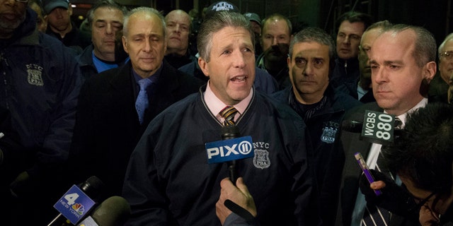 Dec. 20,2014: Patrick Lynch, head of the Patrolmen's Benevolent Association, speaks during a news conference after the bodies of two fallen NYPD police officers were transported from Woodhull Medical Center in New York. (AP Photo/John Minchillo)
