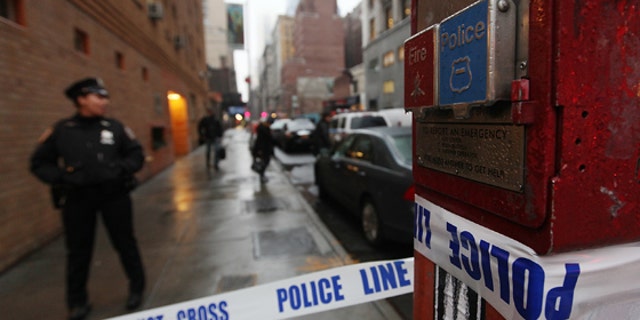 NEW YORK, NY - DECEMBER 10:  Police cordon off the scene of a fatal shooting at 202 West 58th Street in Manhattan on December 10, 2012 in New York City.  The victim, identified as a male was shot in the head in broad daylight on the sidewalk and has since been pronounced dead.  (Photo by Mario Tama/Getty Images)