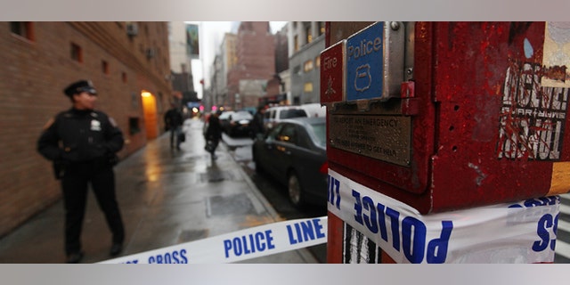 NEW YORK, NY - DECEMBER 10: Police cordon off the scene of a fatal shooting at 202 West 58th Street in Manhattan on December 10, 2012 in New York City. The victim, identified as a male was shot in the head in broad daylight on the sidewalk and has since been pronounced dead. (Photo by Mario Tama/Getty Images)