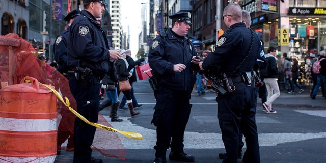 NEW YORK, NY - NOVEMBER 14: Police officers keep watch in Times Square following a series of terrorist attacks in Paris on November 14, 2015 in New York City. Security in New York City has increased following the coordinated assault on Paris which ISIS claimed responsibility for. At least 120 people have been killed and over 200 injured, 80 of which seriously. (Photo by Andrew Renneisen/Getty Images)
