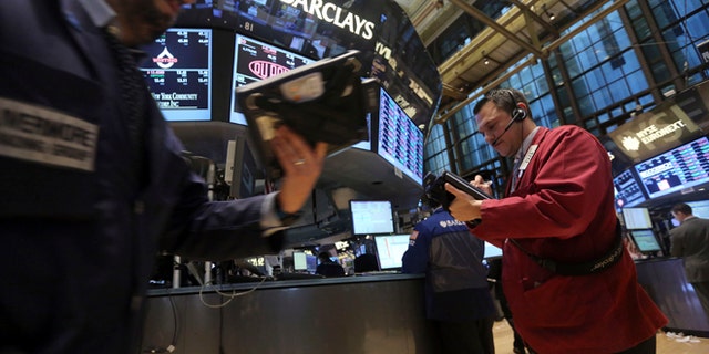 FILE - In this Thursday, Jan. 3, 2013 file photo, traders work on the floor of the New York Stock Exchange. Stock futures are mixed, Friday, Jan. 18, 2013, after major indexes surged throughout the week, with the Standard and Poor's 500 repeatedly marking new five-year highs. (AP Photo/Mary Altaffer, File)