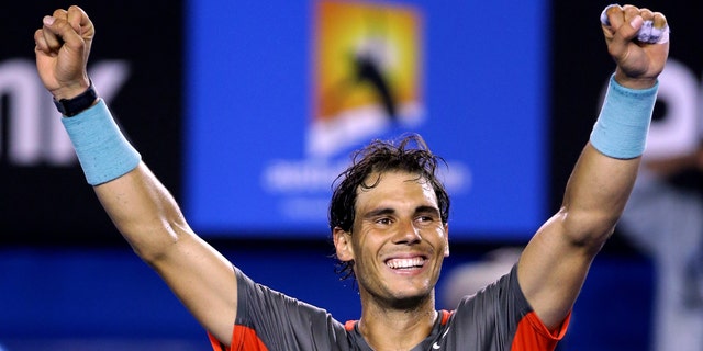 Rafael Nadal of Spain celebrates after defeating Roger Federer of Switzerland during their semifinal at the Australian Open tennis championship in Melbourne, Australia, Friday, Jan. 24, 2014.(AP Photo/Aaron Favila)