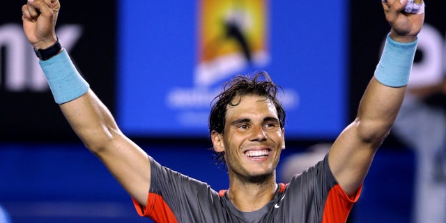 Rafael Nadal of Spain celebrates after defeating Roger Federer of Switzerland during their semifinal at the Australian Open tennis championship in Melbourne, Australia, Friday, Jan. 24, 2014.(AP Photo/Aaron Favila)