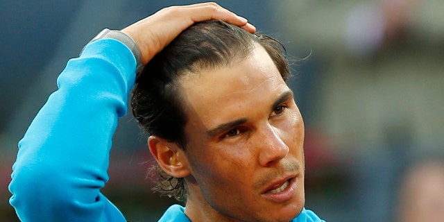 Rafael Nadal of Spain makes a speech after losing to Andy Murray of Britain during the men's final at the Madrid Open Tennis tournament in Madrid, Spain, Sunday, May 10, 2015. (AP Photo/Paul White)