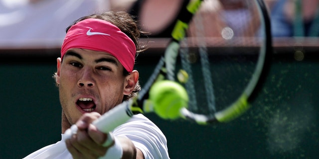 FILE - In this March 20, 2010 file photo, Rafael Nadal of Spain returns a shot to Ivan Ljubicic of Croatia during their match at the BNP Paribas Open tennis tournament in Indian Wells, Calif. Rafael Nadal has pulled out of the London Olympics, saying he is 'not in condition' to compete. Nadal said in a statement Thursday July 19, 2012 it is one of the saddest moments of his career and that he will not travel with the Spanish delegation to London. He was set to be the flag bearer for Spain during the opening ceremony. Nadal won gold in Beijing in 2008. (AP Photo/Mark J. Terrill, File)