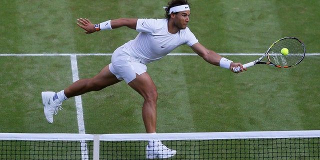 Rafael Nadal of Spain returns a ball to Dustin Brown of Germany, during their singles match at the All England Lawn Tennis Championships in Wimbledon, London, Thursday July 2, 2015. (AP Photo/Kirsty Wigglesworth)