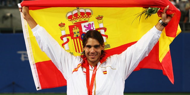 BEIJING - AUGUST 17: Rafael Nadal of Spain celebrates winning the gold medal against Fernando Gonzalez of Chile during the men's singles gold medal tennis match held at the Olympic Green Tennis Center during Day 9 of the Beijing 2008 Olympic Games on August 17, 2008 in Beijing, China. (Photo by Clive Brunskill/Getty Images)