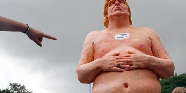 A statue of a naked Donald Trump.