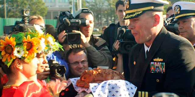 FILE 2012: Cmdr. Joseph R. Darlak, right foreground, was relieved of command in San Diego after an investigation for demonstrating poor leadership and failing to ensure proper officer conduct during the three-day September stop.