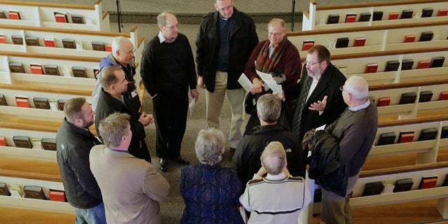 In this Thursday, Feb. 6, 2014 photo, religious leaders of various denominations in Fremont, Neb., meet at the First United Methodist Church, following a service, part of 40 Days of Prayer for Fremont. The prayer and meeting comes ahead of a special election Tuesday, Feb. 11, to decide whether to drop housing restrictions against undocumented immigrants, as had been approved by Fremont voters in the 2010 elections. The city leaders scheduled the special election because of concerns the housing restrictions could cost them millions in federal grants and lead to more lawsuits against the city. (AP Photo/Nati Harnik)